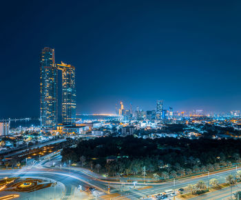 High angle view of illuminated buildings in city at night