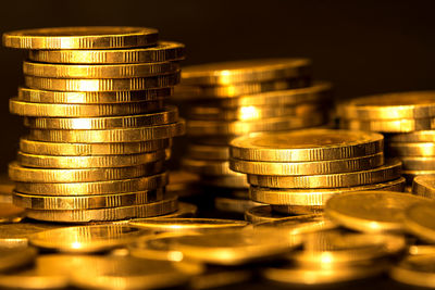 Close-up of gold coins on table 