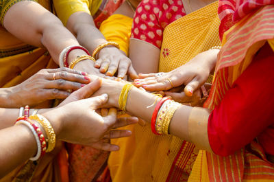 Midsection of women stacking hands