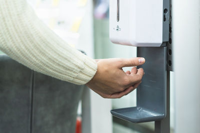 Cleaning, washing hands using automatic sanitizer dispenser concept.