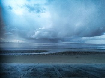 Scenic view of sea against storm clouds