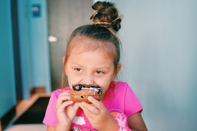 Portrait of cute girl holding eyeglasses
