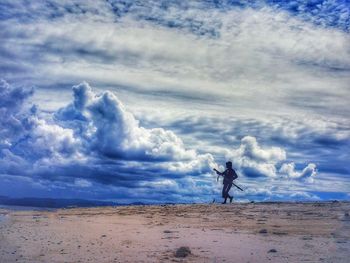 Man standing on sand against sky