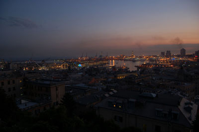 High angle view of illuminated buildings against sky at night