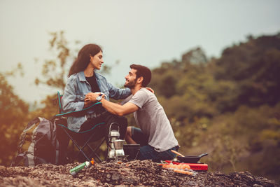 Young couple sitting outdoors