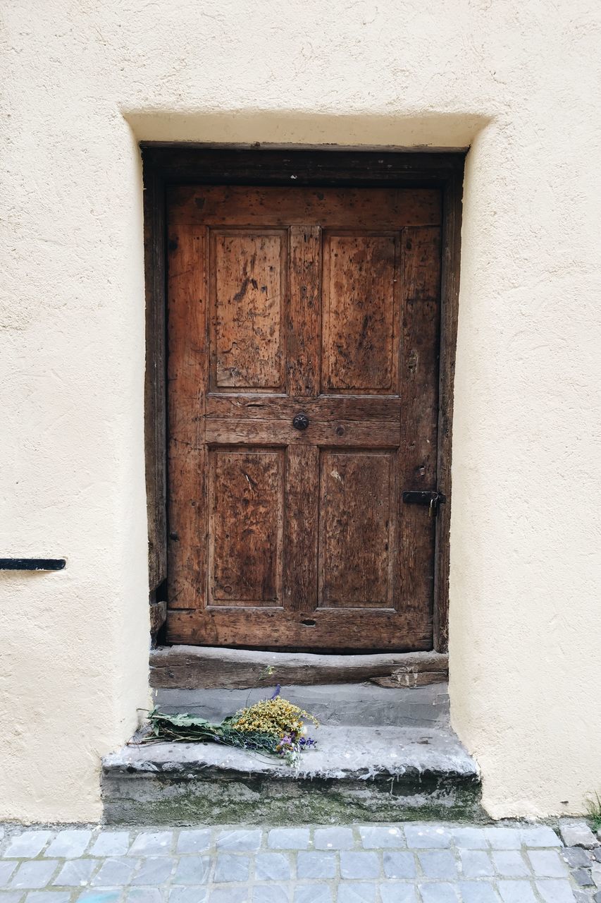 building exterior, built structure, architecture, door, closed, entrance, house, wall - building feature, window, wall, outdoors, safety, protection, cobblestone, day, sidewalk, old, residential structure, closed door, building