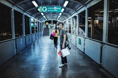 People walking on railroad station platform