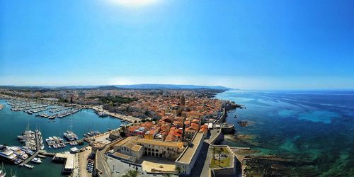 High angle view of cityscape by sea against sky