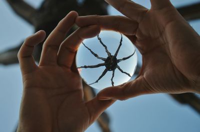 Midsection of woman holding hands against sky