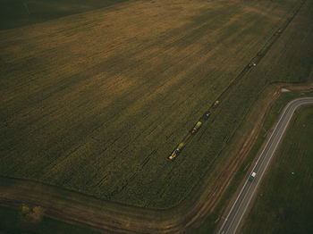 Aerial view of machinery working in agricultural field