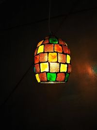 Low angle view of illuminated pendant lights hanging from ceiling