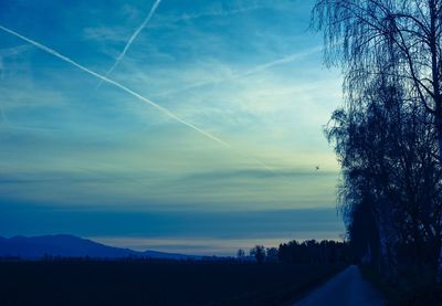 Vapor trail in sky at sunset