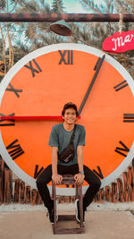Portrait of young man sitting outdoors