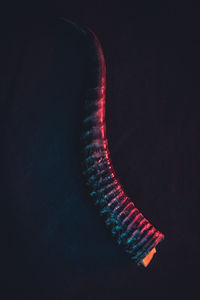 High angle view of illuminated lighting equipment against black background