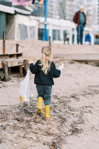 Side view of boy playing with umbrella