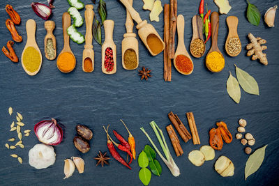High angle view of various spices on marble