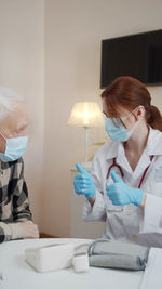 Doctor gesturing while talking to patient