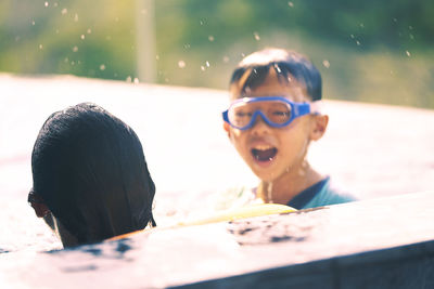 Portrait of smiling boy swimming in pool