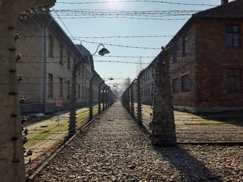 Alley amidst buildings in city against clear sky