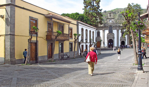 Woman walking in front of historical building