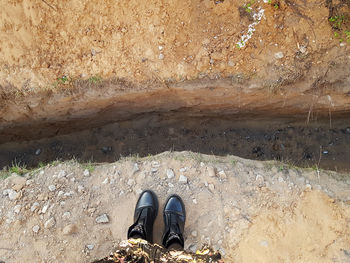 Low section of person standing on rock