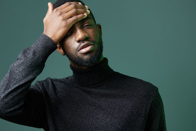 Low angle view of young man against black background