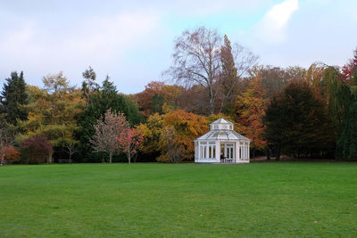 Gazebo against autumn trees at park against sky