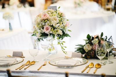 Close-up of flower vase on dining table