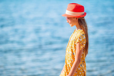 Midsection of woman standing against sea