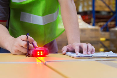 Midsection of man working at table