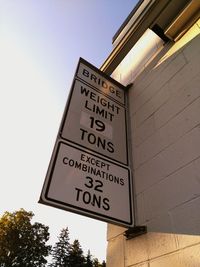 Low angle view of signboard against clear sky