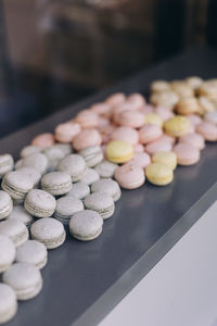 Pastel colored macaroons in a shop window in paris, france