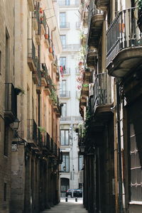 Narrow street amidst buildings in city