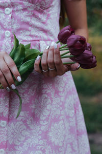 Midsection of woman holding plant