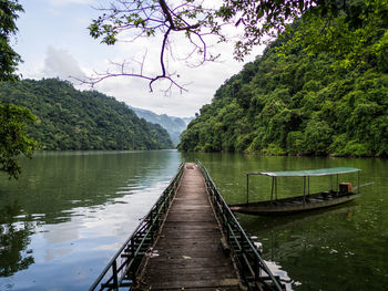 Jetty in lake against sky