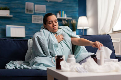 Man sitting on bed at home