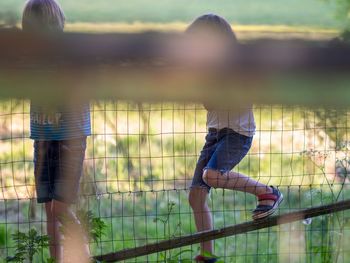 Boys playing by fence at park