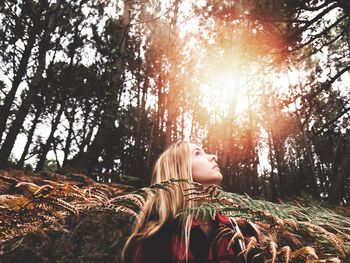 View of woman standing in forest foliage
