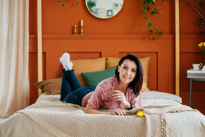 Young woman enjoys herself sitting at home during self-isolation, lockdown, because of covid19.