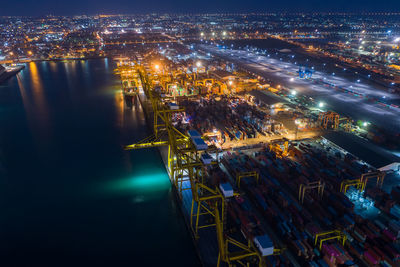 Shipping containers cargo transportation import and export international service by the sea at night 