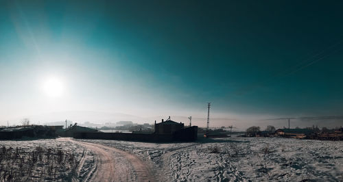 Scenic view of snow covered landscape against sky