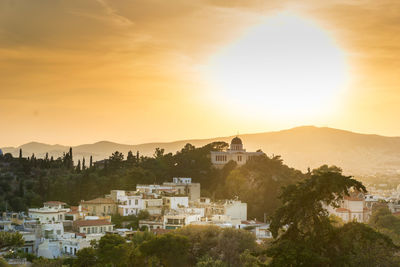 View of town against sky during sunset