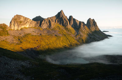 Scenic view of sun-kissed peaks against clear sky. ideal for nature, landscapes, travel projects. 