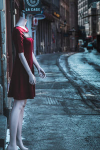 Woman walking on street in city