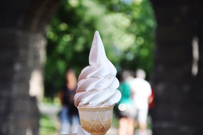 An icecream cone with chocolate and vanillia icecream