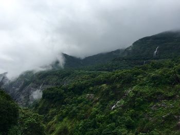 Scenic view of mountains against cloudy sky