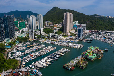 High angle view of modern buildings by sea in city