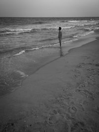 Full length of woman on beach against sky