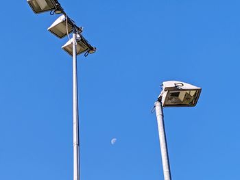 Low angle view of street light against blue sky