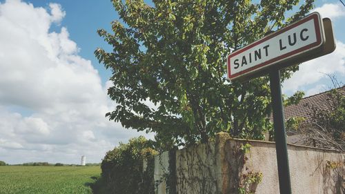 Low angle view of road sign against sky